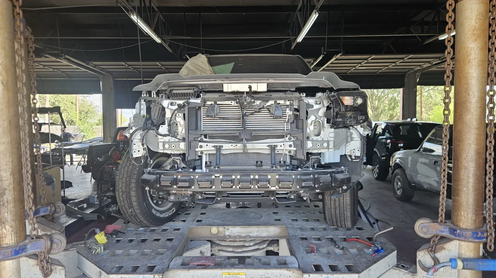 Truck on the frame machine during collision repair at Collision Masters